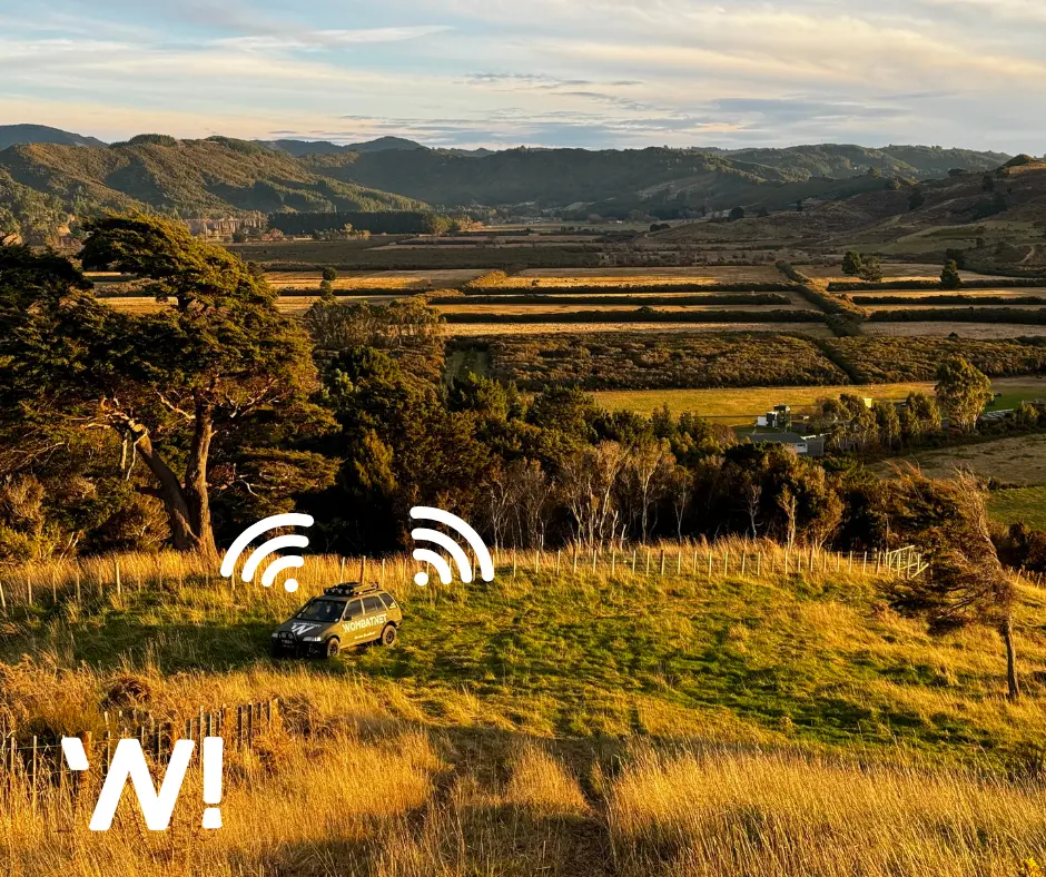 A WombatNET vehicle on hilly countryside terrain with a rural backdrop and cast from the setting sun.
